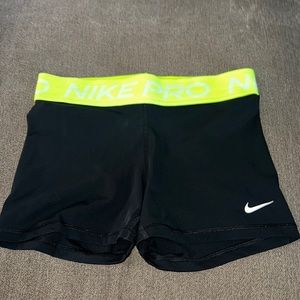 black nike pros with neon band
